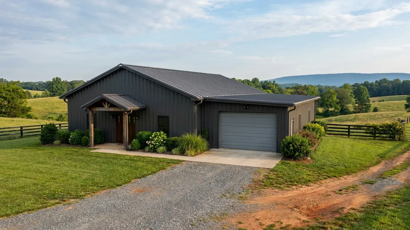 A completed 40x60 barndominium showing a residential entry on one end and a wide shop door on the other under one continuous roof.