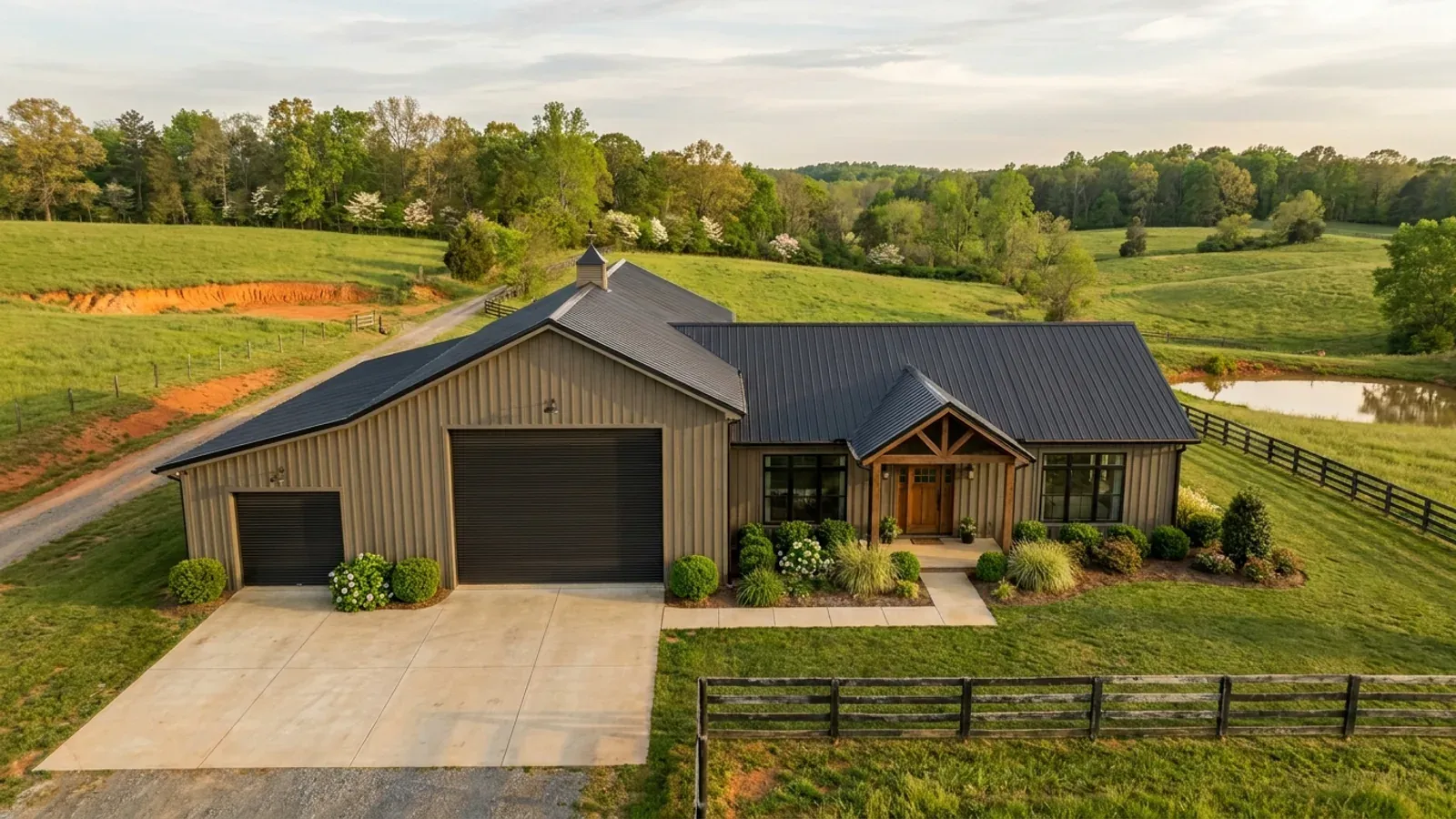 A barndominium with a tall, deep RV garage bay attached to the residence under one continuous roof.