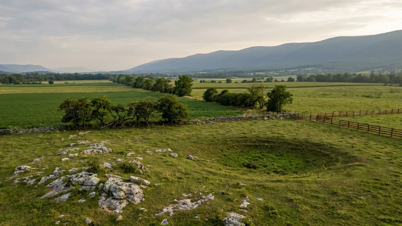 The Shenandoah Valley floor in pasture and cropland with limestone outcrops and the Blue Ridge on the horizon.